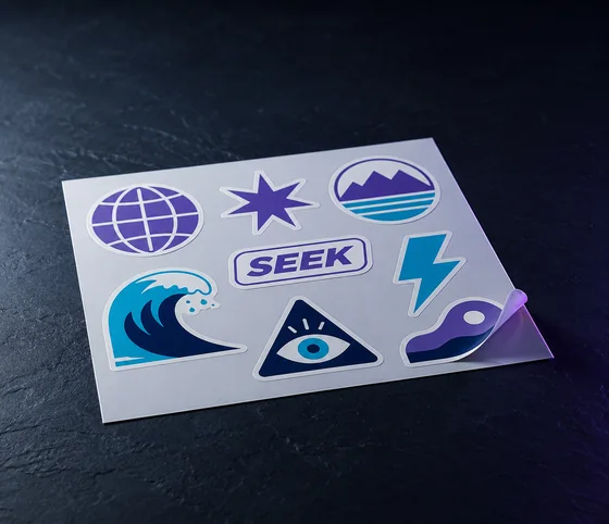 Die-cut vinyl stickers, one peeled to show the cut